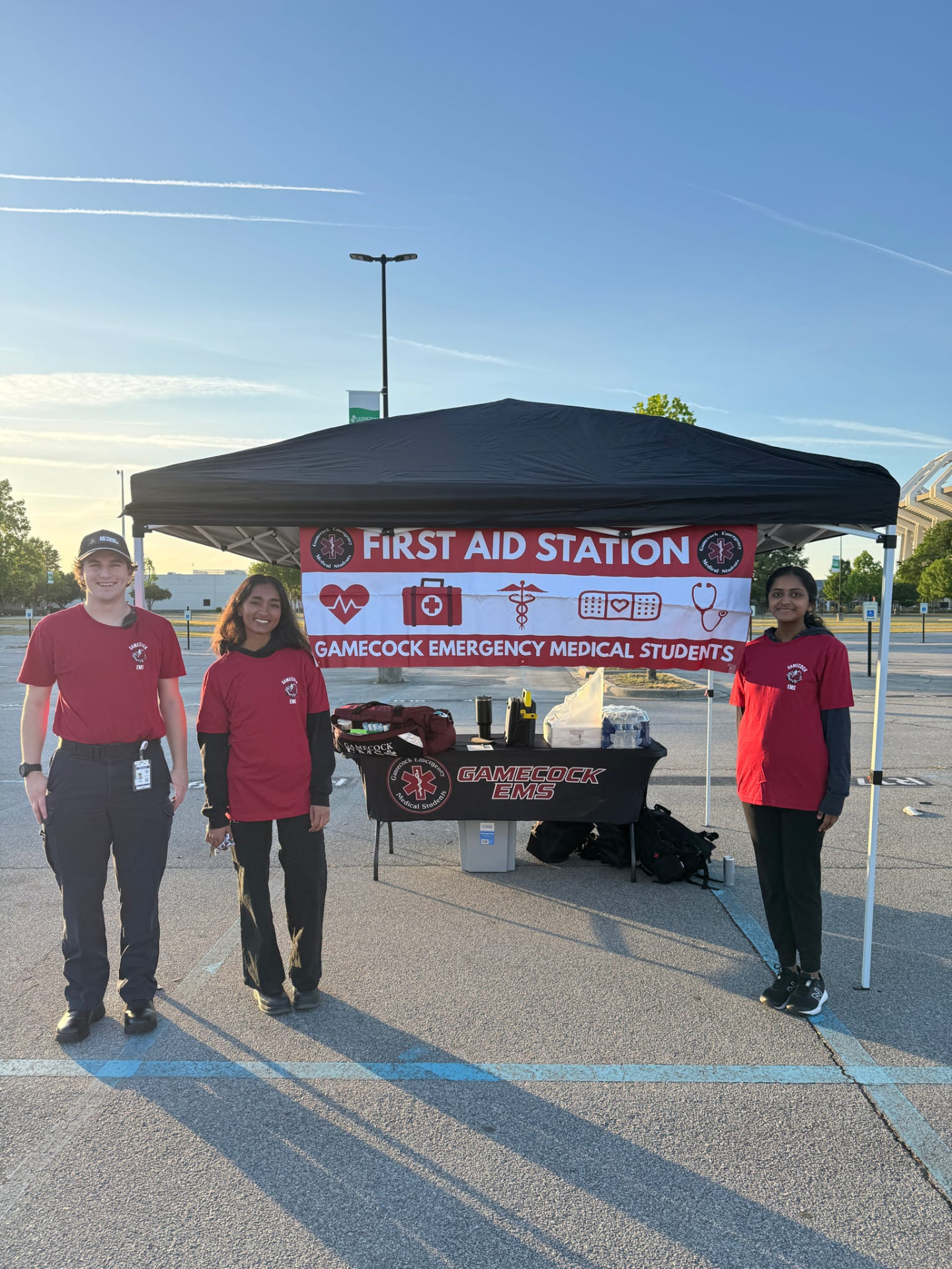 Gamecock EMS members at the First Aid Station tent in a parking lot