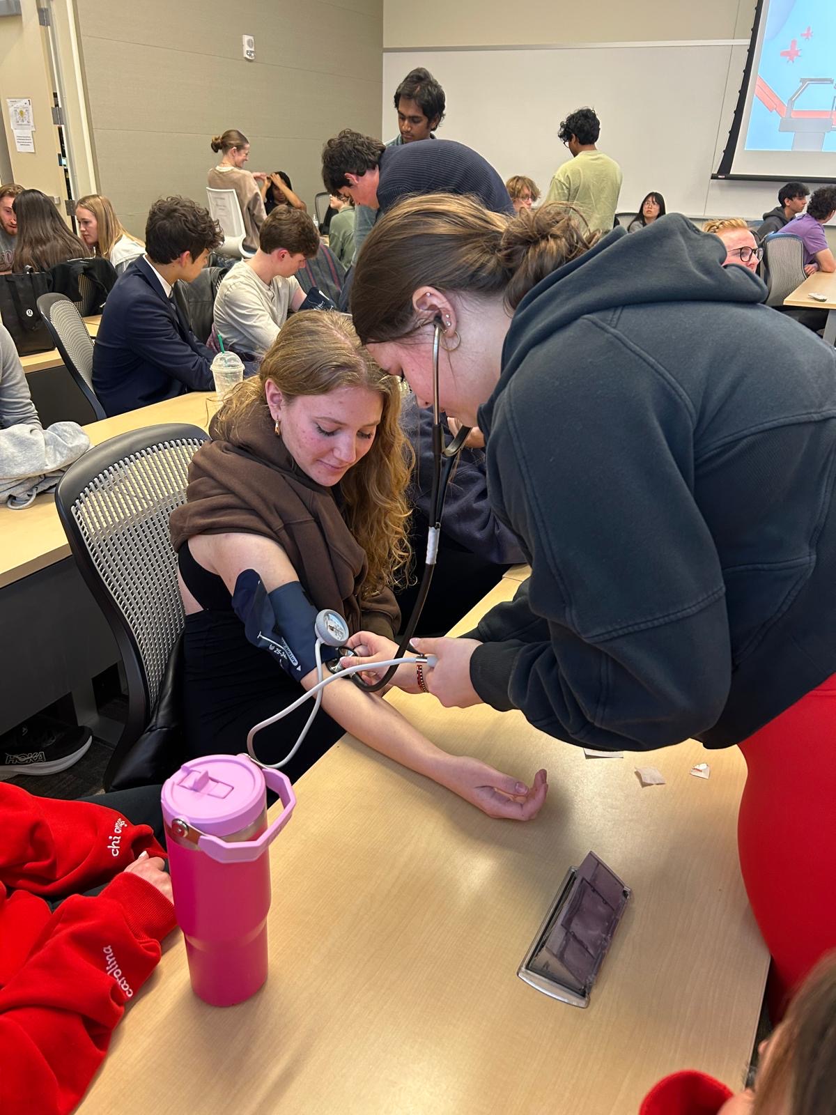 Students practicing blood pressure assessment