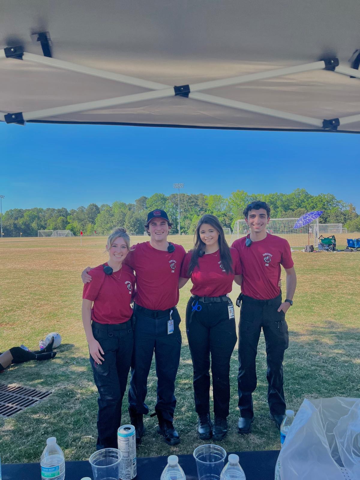 Four Gamecock EMS members staffing a standby at a soccer field