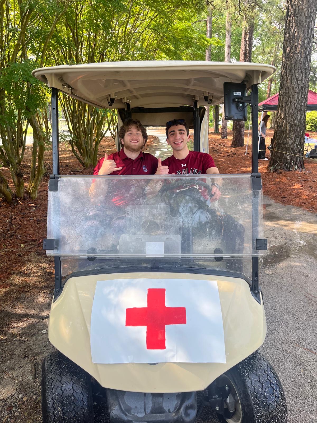 Members staffing a medical golf cart at a campus event