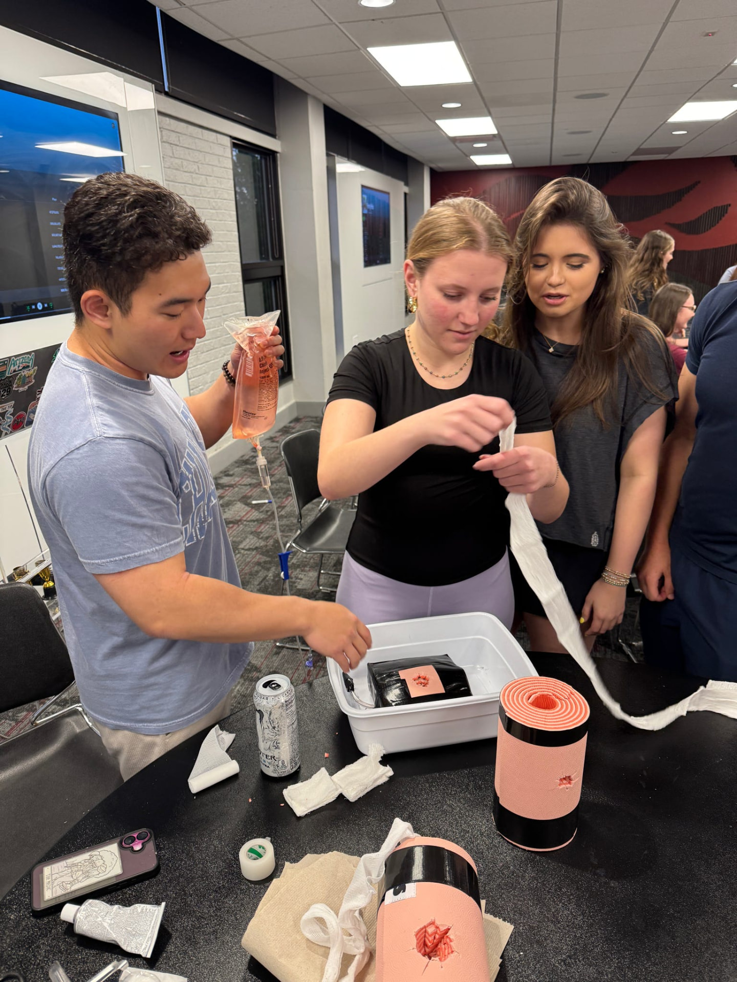 Gamecock EMS students practicing wound packing and IV skills at an EMT-B lab