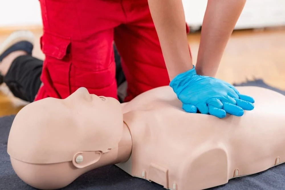 Chest compressions being performed on a CPR manikin